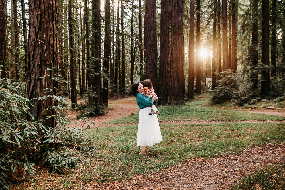 jenn chen holding her baby in the redwoods