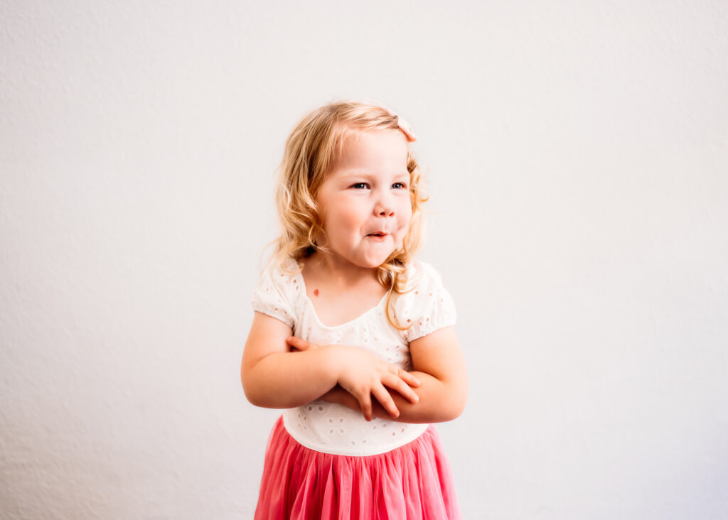 toddler making silly faces for her personality portrait session