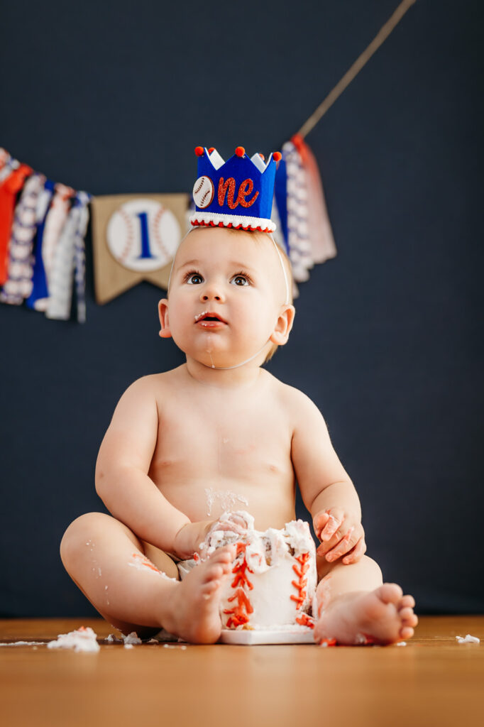 one year old baby for his cake smash photos in a photography studio