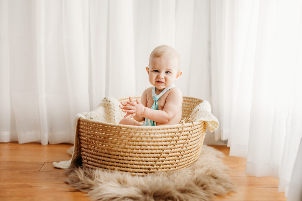 baby sitting in a basket during a photography session
