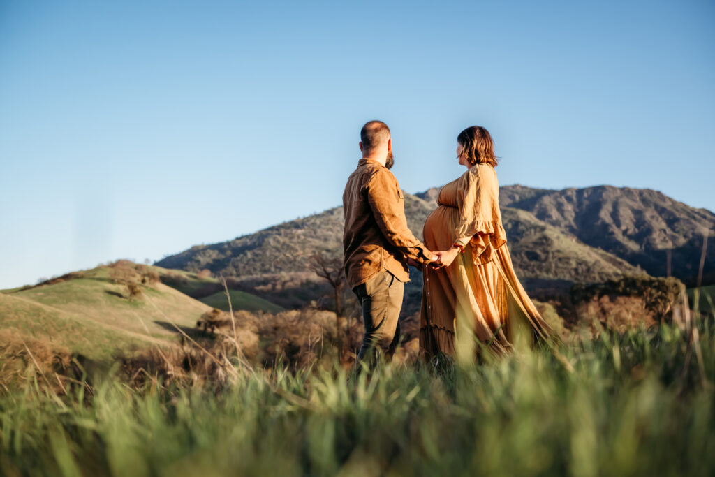 Low shot of a pregnant woman and her husband at mt diablo state park.