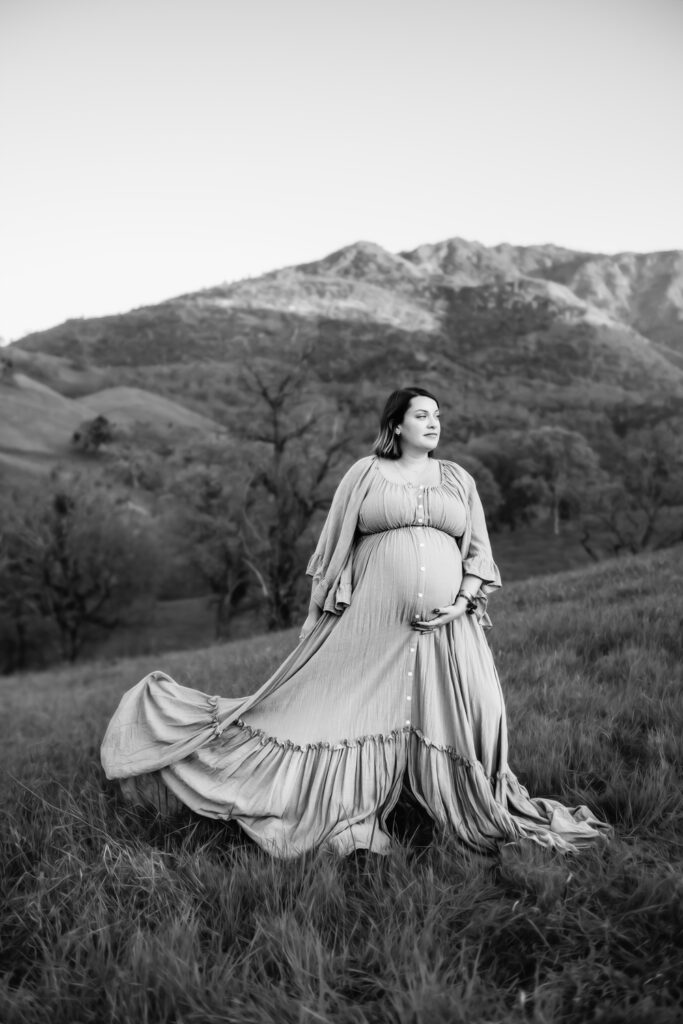 black and white image of a pregnant mama looking calmly off camera.