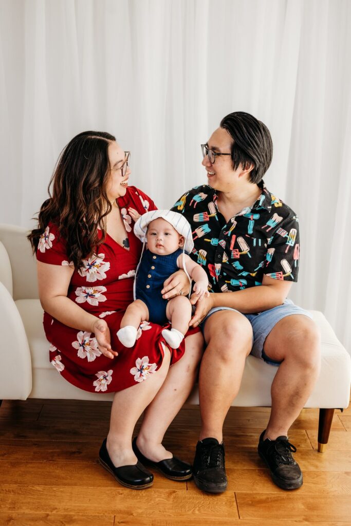 family of three celebrating their baby's 100 days
