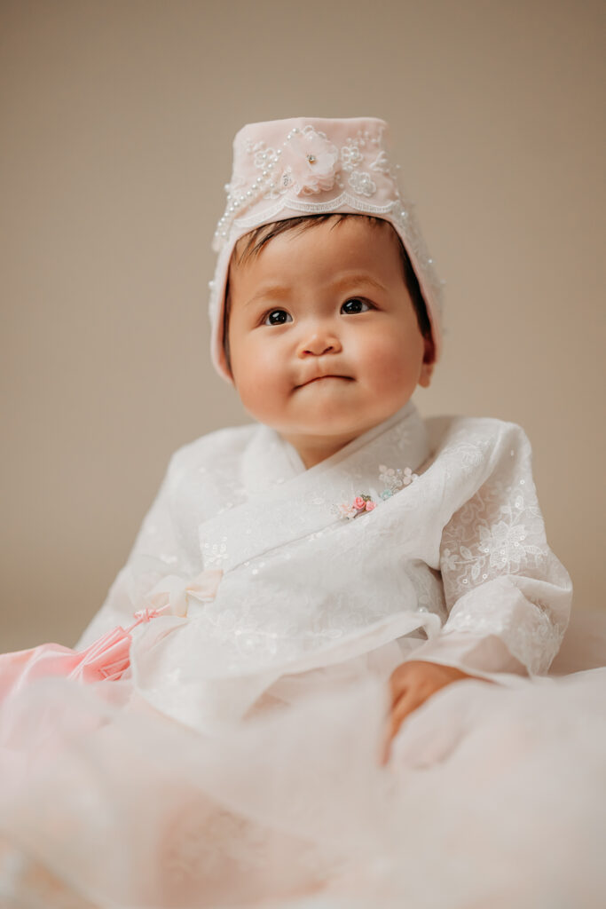 baby in traditional hanbok attire for a studio photography session