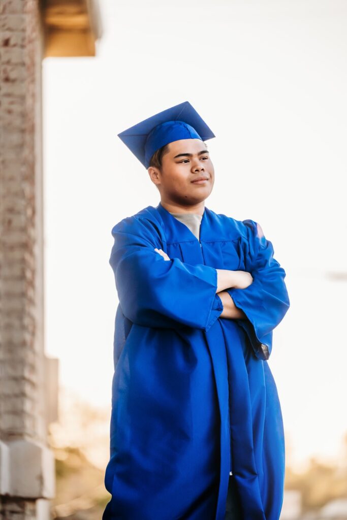Senior looking off wearing cap and gown