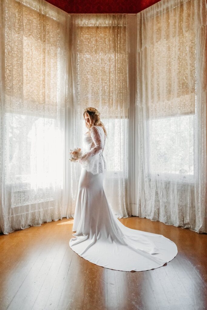 Bride in front of lace curtains at the John Muir house.