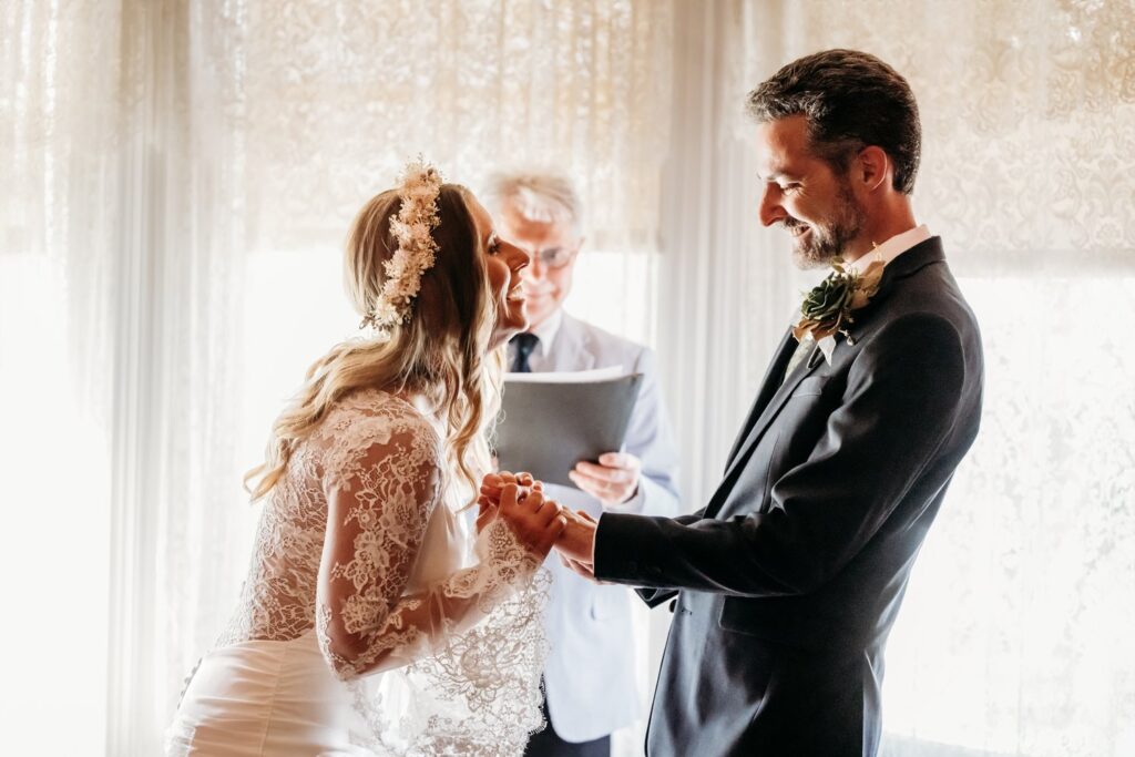 Husband and wife smiling during their wedding ceremony