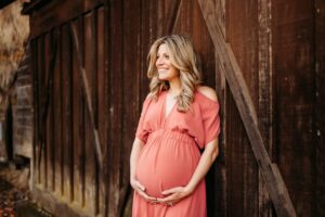 pregnant mama smiles looking off at her family