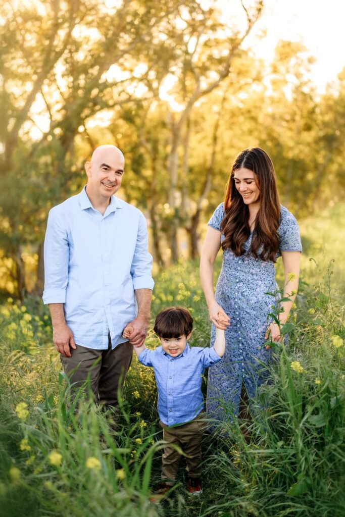 most popular wildflower photoshoot location in walnut creek. a family walking through a field holding hands
