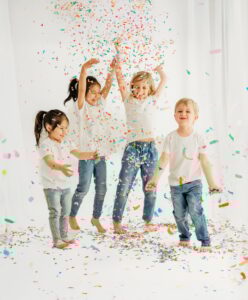 4 kids having a confetti party