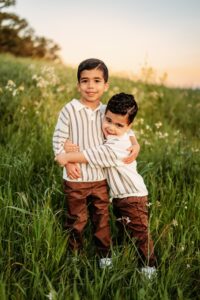 2 brothers hug and look at camera