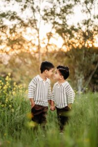 brothers laugh at the touch their noses together