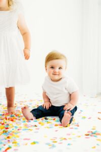 baby looks at camera smiling in a photography studio
