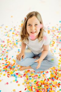 girl in photography studio during confetti mini session