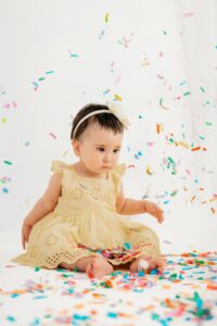 baby watches confetti fall