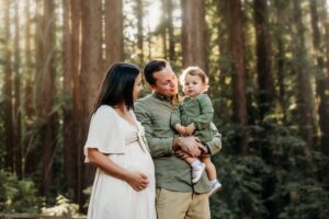 family of 3 getting maternity photos in a east bay redwood forest