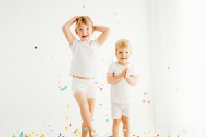 siblings laughing during their confetti mini session