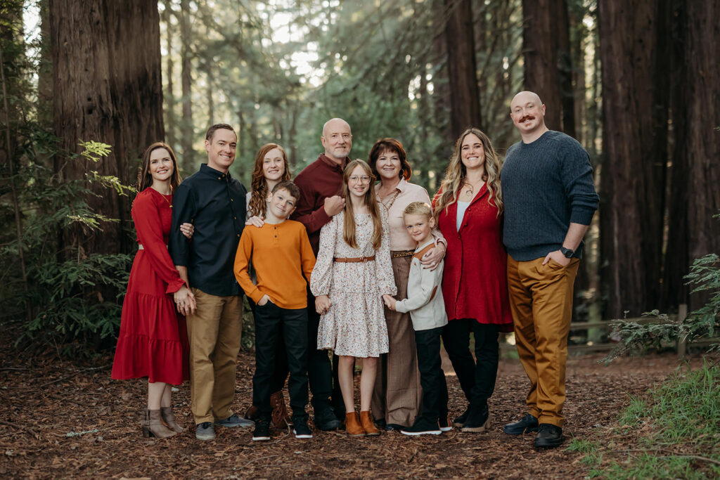 extended family photos with grandparents and aunts uncles and cousins. they were mustard, red and navy colors which pop against the redwoods