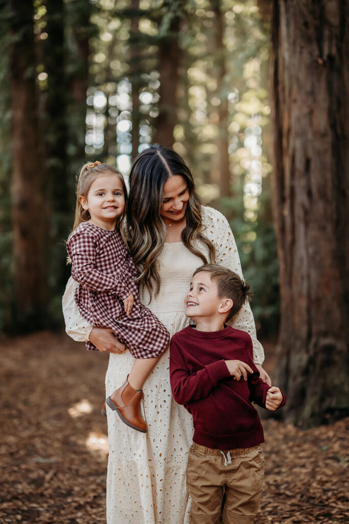 mama holder daughter and looks down at her son