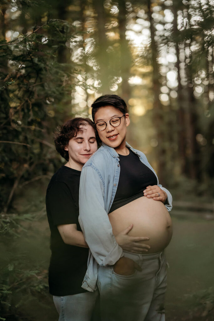 pregnant mama looks over her shoulder towards her wife