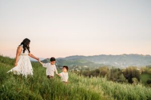 2 boys lead their mama down the hillside in lafayette