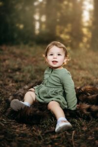 toddler sits on a brown furry blanket