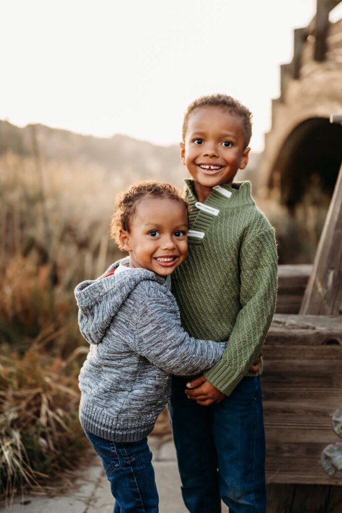 2 young brothers smile at the camera