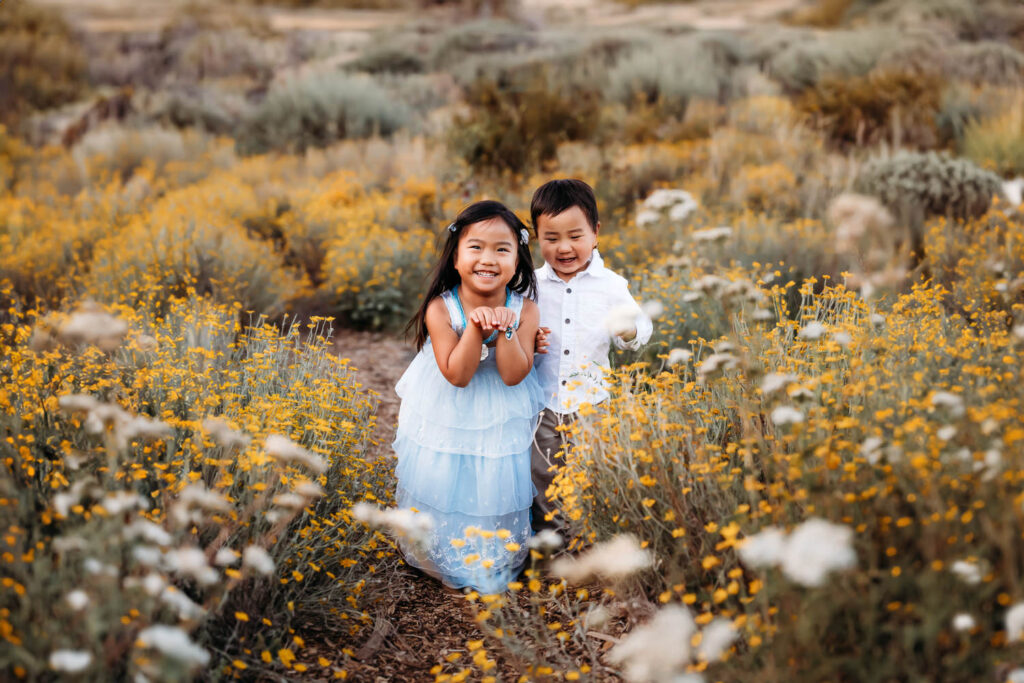 stunning wildflower field where 2 kids run around and act silly